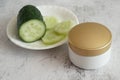 Cucumber cosmetic cream face and hand on silver background, skin and body care lotion