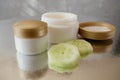 Cucumber cosmetic cream face and hand on wooden background, skin and body care lotion