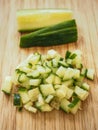 Cucumber cutted in dices over a wood table