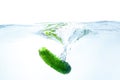 Cucumber dropped in blue water on white Royalty Free Stock Photo