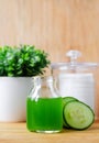 Cucumber juice in a small glass jar for preparing natural facial toner. Homemade cosmetics. Royalty Free Stock Photo