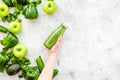 Cucumber, pepper, apple, celeriac. Vegetables for greeny organic smoothy for sport diet on stone background top view Royalty Free Stock Photo