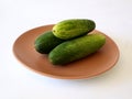 three cucumbers piled on a plate
