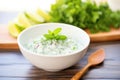 cucumber raita in a white bowl with mint garnish Royalty Free Stock Photo