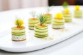 cucumber rounds layered with dill on white plate