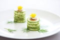cucumber rounds layered with dill on white plate Royalty Free Stock Photo