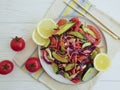 Cucumber salad healthy , tomatoes, sticks fresh lemon on a white wooden background Royalty Free Stock Photo