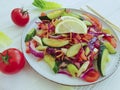 Cucumber salad healthy vegetable nutrition , tomatoes, sticks fresh lemon on a white wooden background Royalty Free Stock Photo