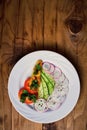 Cucumber salad, radish, pepper and parsley on a wooden background