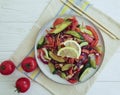 Cucumber salad, tomatoes, sticks, lemon on a white wooden background Royalty Free Stock Photo