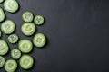 Cucumber slices are arranged on a black surface. AI generative image