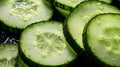 Cucumber slices with water drops on a black background close up