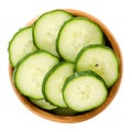 Cucumber slices in wooden bowl over white Royalty Free Stock Photo