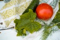 cucumber and tomato and dill on a linen napkin with embroidery. Fresh vegetables from the garden. leaves of greenery. Royalty Free Stock Photo