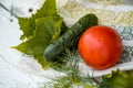 cucumber and tomato and dill on a linen napkin with embroidery. Fresh vegetables from the garden. leaves of greenery. Royalty Free Stock Photo