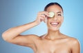 Cucumber, woman and portrait face for beauty, clean wellness diet and blue studio background. Happy model, eyes and Royalty Free Stock Photo