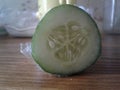 Slice of green cucumber on a wooden table Royalty Free Stock Photo