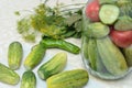 Cucumbers with green hot pepper on the table with glass jar with pickled vegetables cucumber and tomato with herbs and Royalty Free Stock Photo