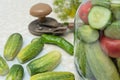 Cucumbers with green hot pepper on the table with glass jar with pickled vegetables cucumber and tomato with herbs and Royalty Free Stock Photo