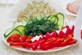 Cucumbers, tomatoes, Bulgarian pepper, radish, herbs. Beautiful serving of the festive table