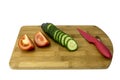 Cucumbers and tomatoes on a cutting board