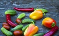 Cucumbers, tomatoes, peppers, on a wooden table