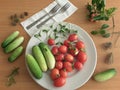 Cucumbers, tomatoes on plate, sunflower sprouts