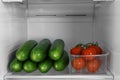 Cucumbers and tomatoes in refrigerator
