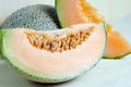 Cucumis melo or melon with half and seeds on wooden plate (Other names are cantelope, cantaloup, honeydew, Crenshaw, casaba, Per Royalty Free Stock Photo