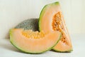 Cucumis melo or melon with half and seeds on wooden plate (Other names are cantelope, cantaloup, honeydew, Crenshaw, casaba, Per Royalty Free Stock Photo