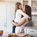 Cuddles with her cutie. a happy mother hugging her cute little girl in the kitchen at home. Royalty Free Stock Photo