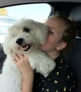 Cuddly hug of a girl and her pet in a car Royalty Free Stock Photo