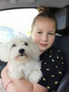 Cuddly hug of a girl and her pet in a car Royalty Free Stock Photo