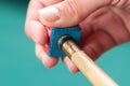 Cue stick with chalk block on green billiard table.Chalk block on pool table Royalty Free Stock Photo