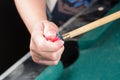Cue stick with chalk block on green billiard table.Chalk block on pool table