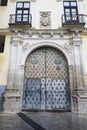 Vintage door of the Episcopal Palace in Cuenca with trim ornaments and forged metal details Royalty Free Stock Photo