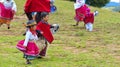 Ecuadorian folk dancers children dressed as Cayambe people performance outdoors traditional dance for tourists