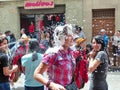 Cuenca, Ecuador, Carnival. Crowd is spraying foam on woman