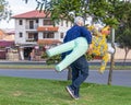 A man carries a rag doll or Monigote to be burned to celebrate New Year\'s Eve