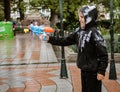 Cuenca, Ecuador, Feb 8, 2018: Child has fun spraying water at fe