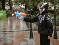 Cuenca, Ecuador, Feb 8, 2018: Child has fun spraying water at festival