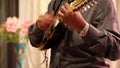 Cuenca, Ecuador - 20161116 - Man Demonstrates Fast Finger Control on Charango Viewed From End of Frets.