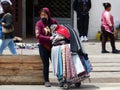 Woman street seller wearing mask, Ecuador