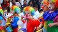 Group of little Children dressed in colorful costumes as clowns at the parade