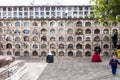 Cuenca, Ecuador - November 1, 2015 -people are seen in front of wall of graves in a cemetary condominium