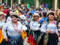 Cuenca, Ecuador. Parade during Carnival. People and dancers spraying foam