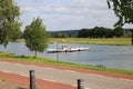 View over cycling track in rural landscape on ferry over river maas to Mook - Bisselt