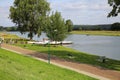 View over cycling track in rural landscape on ferry over river maas to Mook - Bisselt