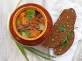 Cuisine of Belarus, russian traditional cuisine : Stewed rabbit with vegetables Goulash in Copper Pot on Wooden shabby Surface, ro