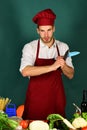 Cuisine and cooking concept. Cook works in kitchen with vegetables Royalty Free Stock Photo